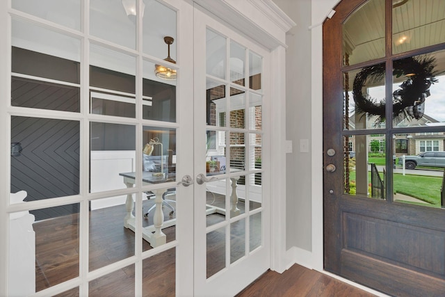 doorway featuring baseboards, french doors, and dark wood finished floors