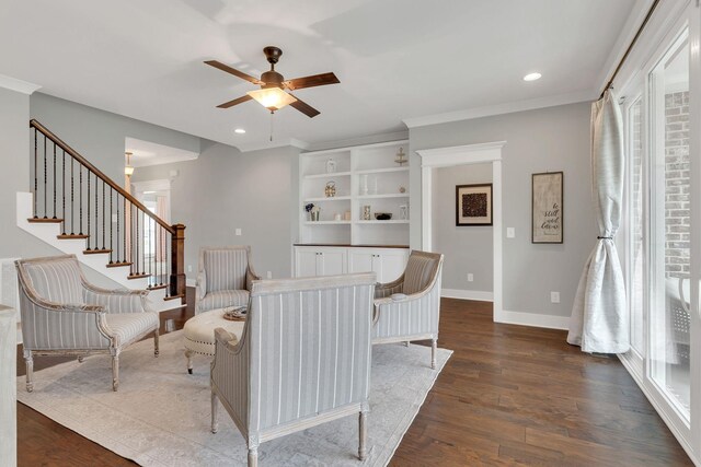 living room with baseboards, a ceiling fan, a healthy amount of sunlight, and dark wood-style floors