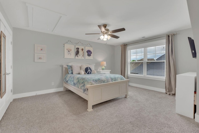 bedroom with light colored carpet, attic access, baseboards, and ceiling fan