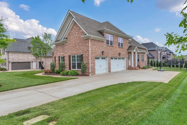view of front of property featuring a front yard, driveway, brick siding, and fence