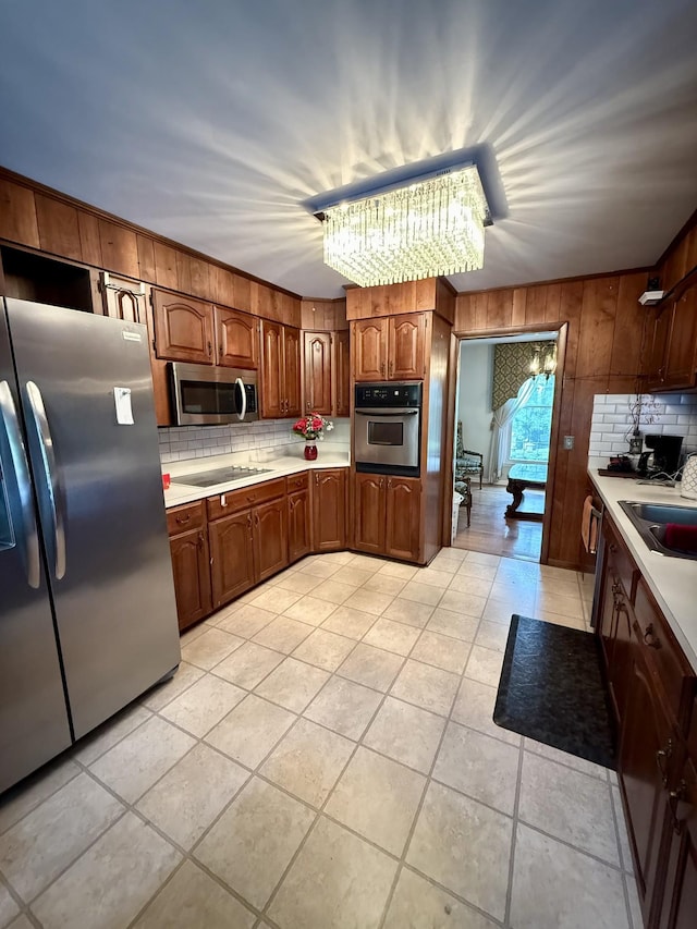 1165 Main St, Lynchburg, TN 37352 - kitchen featuring appliances with stainless steel finishes, decorative backsplash, light countertops, a sink, and light tile patterned flooring