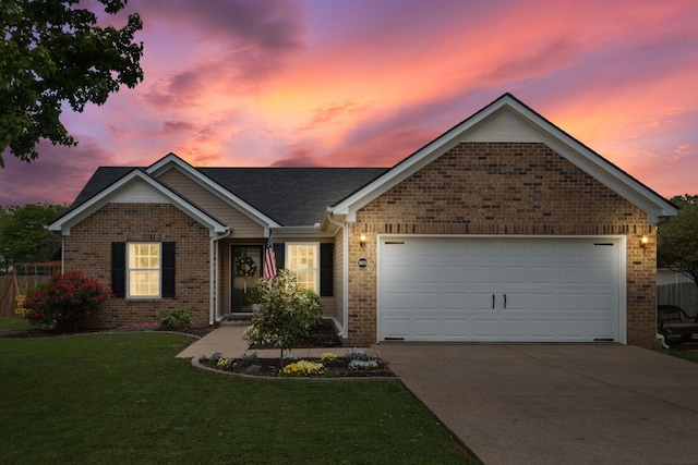 ranch-style home with concrete driveway, a yard, brick siding, and an attached garage