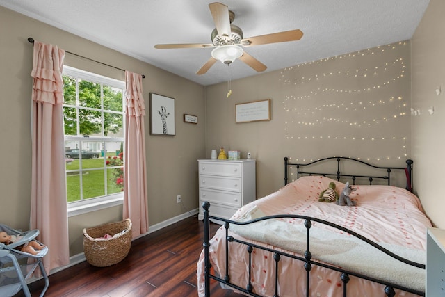 bedroom featuring wood finished floors and baseboards