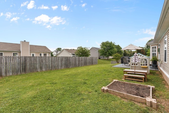 view of yard with a wooden deck, a residential view, a garden, and fence