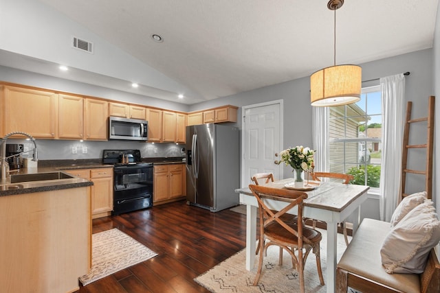 kitchen with light brown cabinets, visible vents, appliances with stainless steel finishes, and a sink