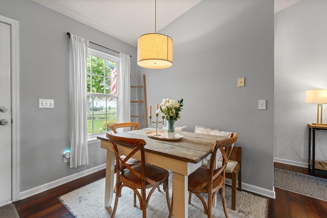 dining area with baseboards and wood finished floors