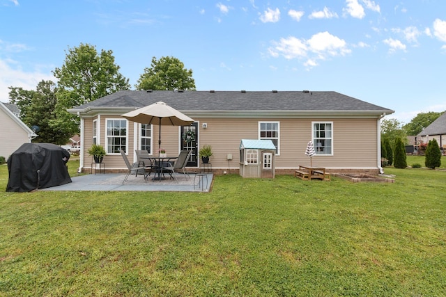 rear view of property featuring a patio and a lawn