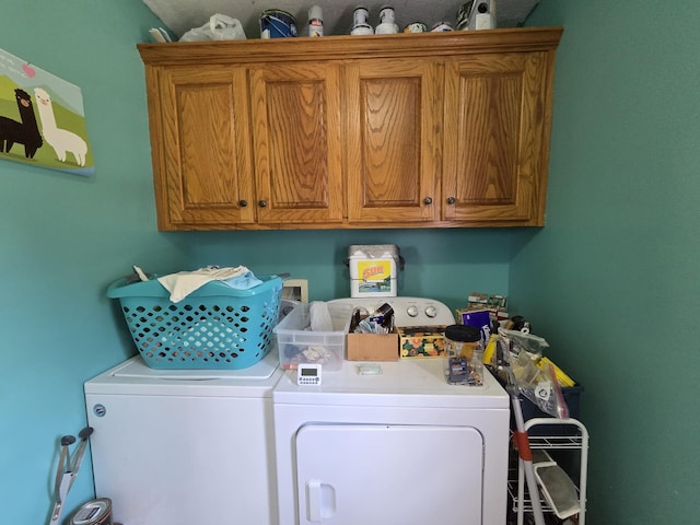laundry room with washer and clothes dryer and cabinet space