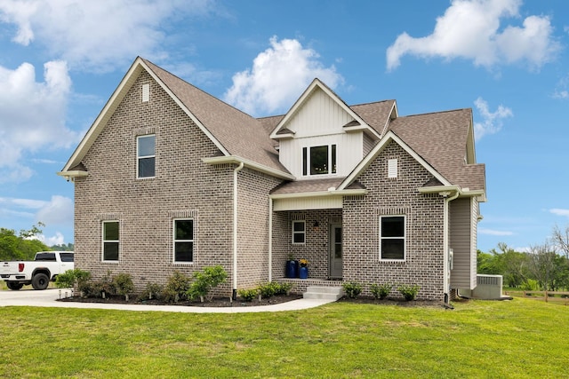 craftsman inspired home featuring a front lawn, board and batten siding, central AC unit, brick siding, and roof with shingles