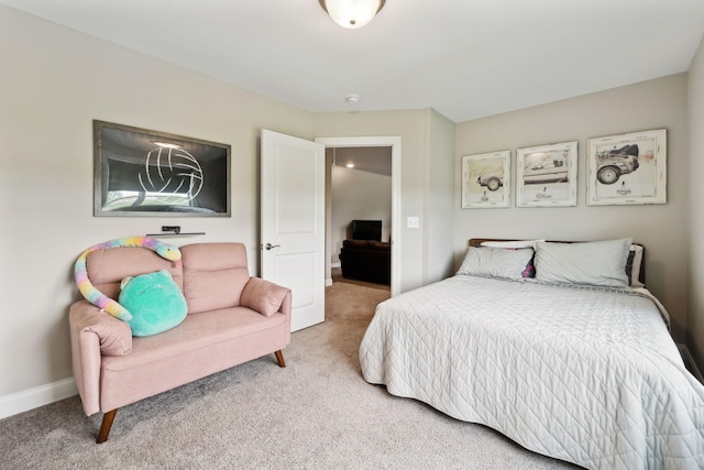 bedroom with baseboards and light carpet
