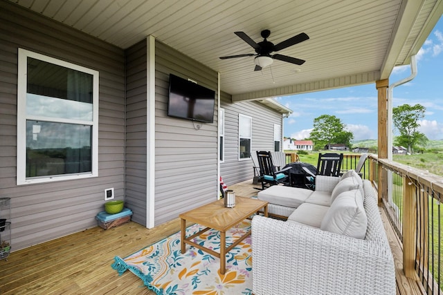 deck featuring outdoor lounge area and a ceiling fan