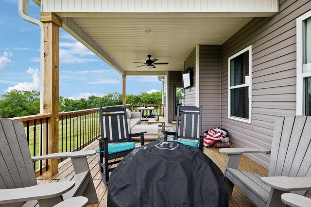 wooden terrace featuring ceiling fan and area for grilling