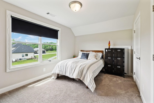 bedroom featuring carpet, visible vents, baseboards, and lofted ceiling