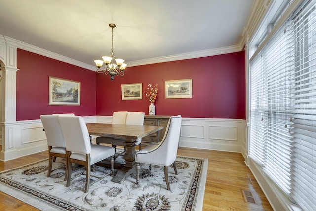 2808 Wynthrope Hall Dr N, Murfreesboro, TN 37129 - dining area with light wood-type flooring, visible vents, a chandelier, crown molding, and wainscoting