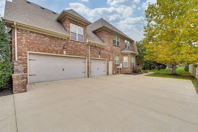 2808 Wynthrope Hall Dr N, Murfreesboro, TN 37129 - view of side of property with a shingled roof, brick siding, and driveway