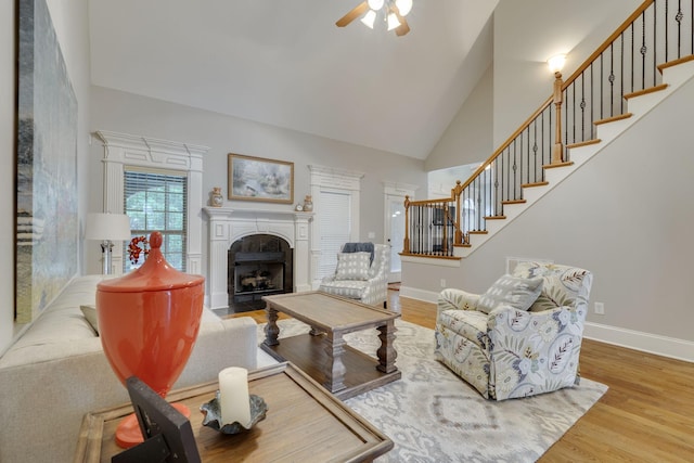 2808 Wynthrope Hall Dr N, Murfreesboro, TN 37129 - living area with stairs, wood finished floors, a ceiling fan, baseboards, and a fireplace with flush hearth
