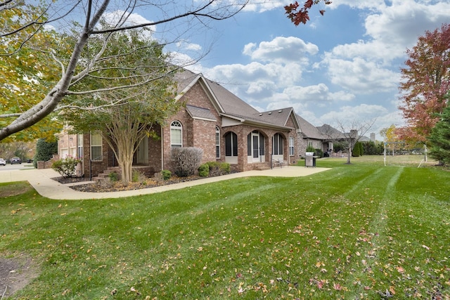 2808 Wynthrope Hall Dr N, Murfreesboro, TN 37129 - exterior space featuring a shingled roof, brick siding, a front yard, and a patio area