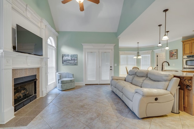 2808 Wynthrope Hall Dr N, Murfreesboro, TN 37129 - living room featuring lofted ceiling, ceiling fan, light tile patterned floors, baseboards, and a tile fireplace