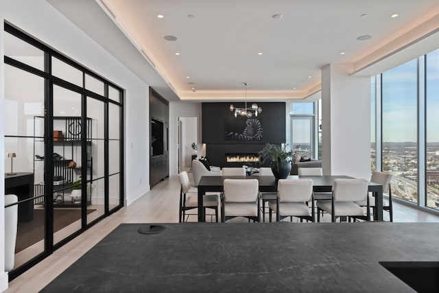 1616 W End Ave Unit 3202, Nashville, TN 37203 - dining space featuring a notable chandelier, light wood finished floors, and plenty of natural light