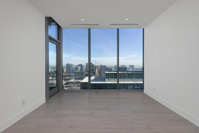 1616 W End Ave Unit 3202, Nashville, TN 37203 - empty room with baseboards, a wall of windows, and wood finished floors