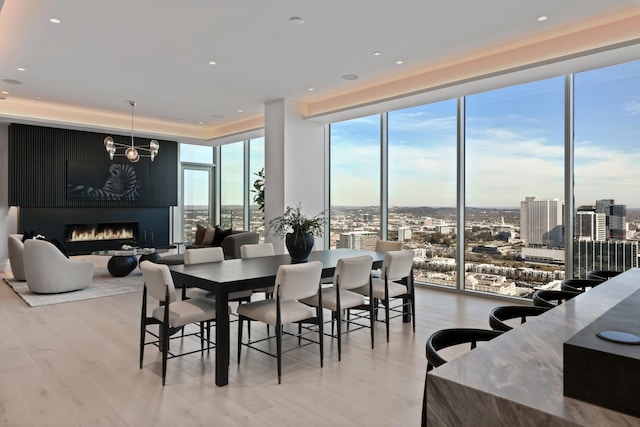 1616 W End Ave Unit 3202, Nashville, TN 37203 - dining room featuring a fireplace, expansive windows, a view of city, and light wood-style floors