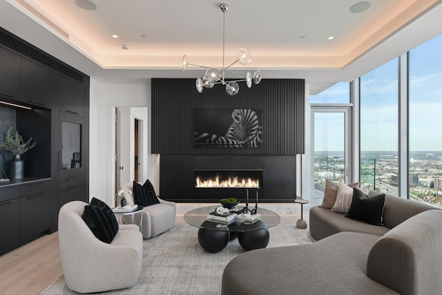1616 W End Ave Unit 3202, Nashville, TN 37203 - living room featuring a chandelier, a high end fireplace, and light wood-style floors