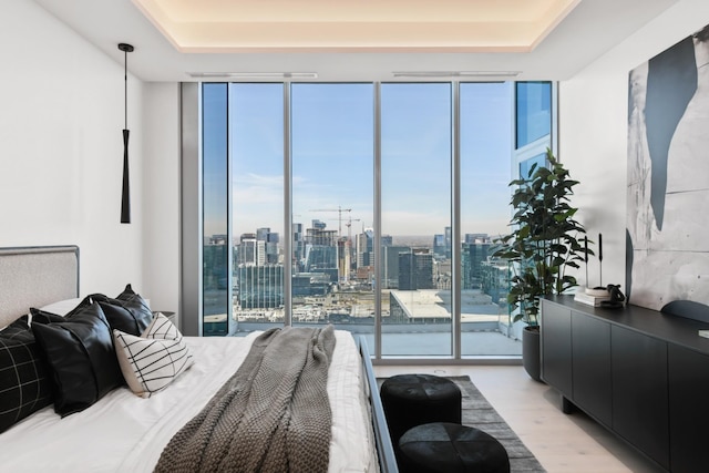 1616 W End Ave Unit 3202, Nashville, TN 37203 - bedroom featuring multiple windows, light wood-style flooring, a tray ceiling, and floor to ceiling windows