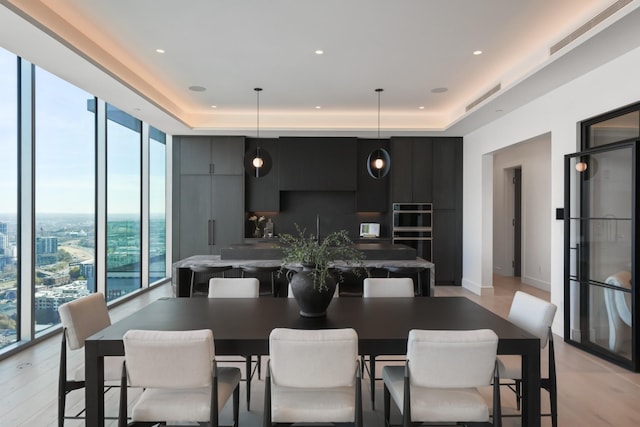 1616 W End Ave Unit 3202, Nashville, TN 37203 - dining area featuring recessed lighting, a wall of windows, a raised ceiling, and light wood-type flooring