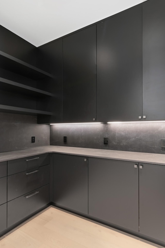 1616 W End Ave Unit 3202, Nashville, TN 37203 - kitchen featuring dark cabinetry, light countertops, modern cabinets, and open shelves