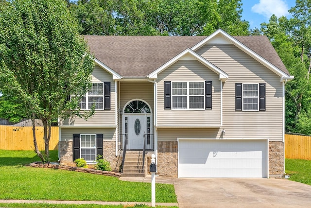1476 Mutual Dr, Clarksville, TN 37042 - split foyer home featuring stone siding, an attached garage, concrete driveway, and a shingled roof