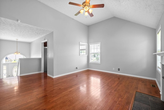 1476 Mutual Dr, Clarksville, TN 37042 - unfurnished living room featuring a ceiling fan, a textured ceiling, plenty of natural light, lofted ceiling, and wood finished floors