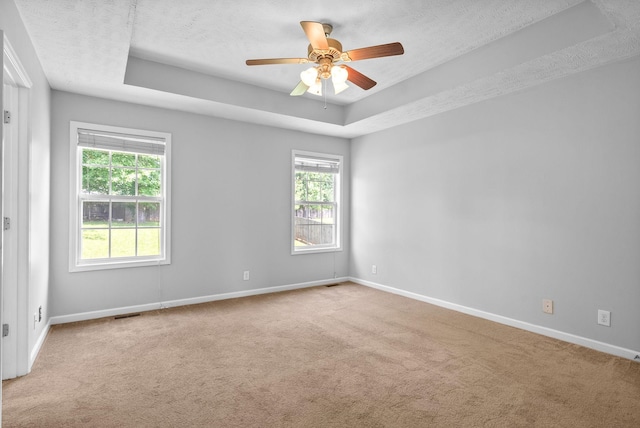 1476 Mutual Dr, Clarksville, TN 37042 - carpeted empty room featuring a tray ceiling, ceiling fan, and a textured ceiling