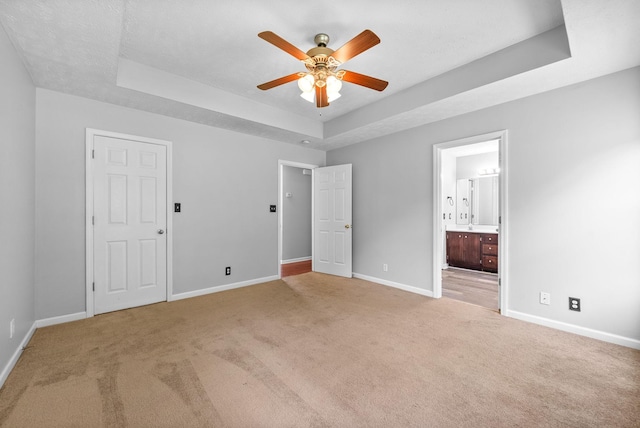 1476 Mutual Dr, Clarksville, TN 37042 - unfurnished bedroom featuring a tray ceiling, carpet flooring, and connected bathroom