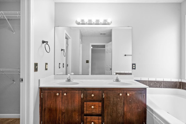 1476 Mutual Dr, Clarksville, TN 37042 - full bathroom featuring double vanity, a walk in closet, and a bath