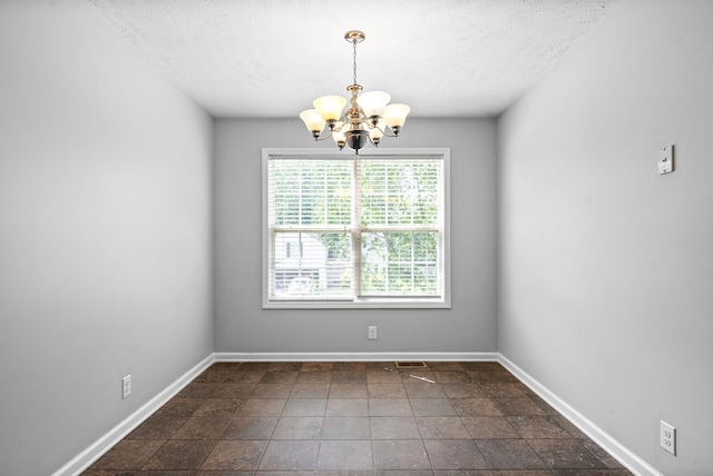 1476 Mutual Dr, Clarksville, TN 37042 - unfurnished room with a chandelier, a textured ceiling, and dark stone finish flooring