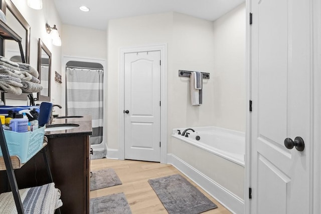 531 Wilson Hollow Rd, Dickson, TN 37055 - bathroom with a shower with curtain, baseboards, a garden tub, vanity, and wood finished floors