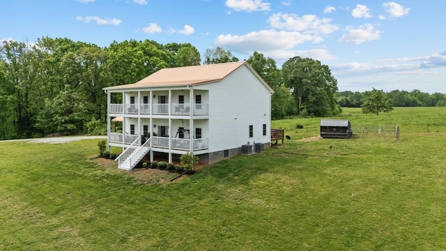 531 Wilson Hollow Rd, Dickson, TN 37055 - back of house with covered porch, a lawn, central air condition unit, and a balcony