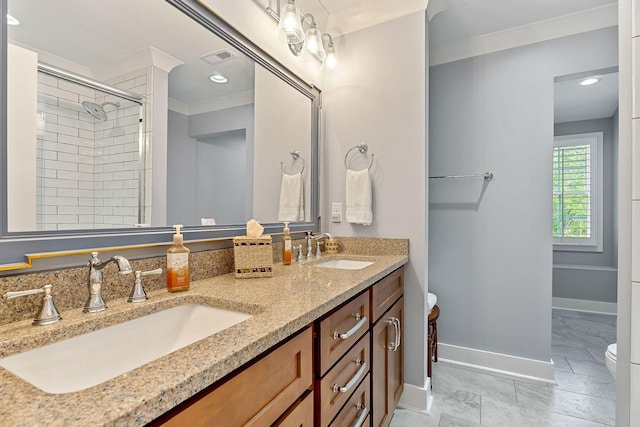 full bath with toilet, baseboards, a sink, and a stall shower