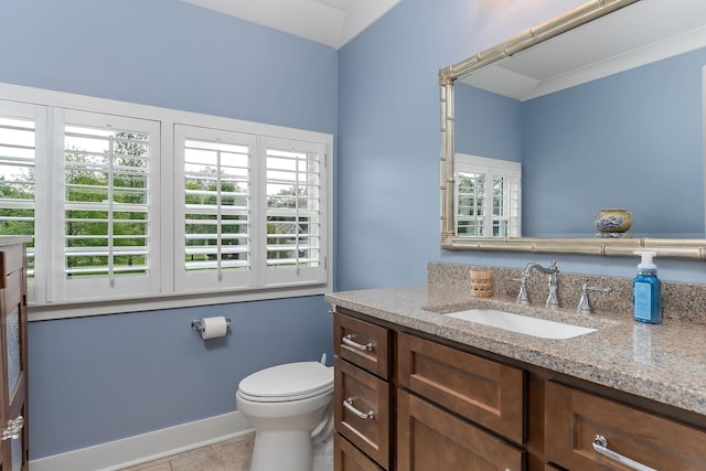 bathroom with toilet, tile patterned flooring, vanity, and baseboards