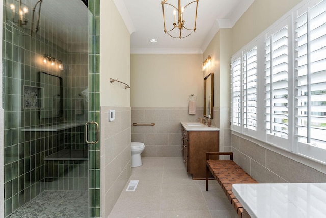 full bath with toilet, tile walls, a shower stall, a chandelier, and ornamental molding