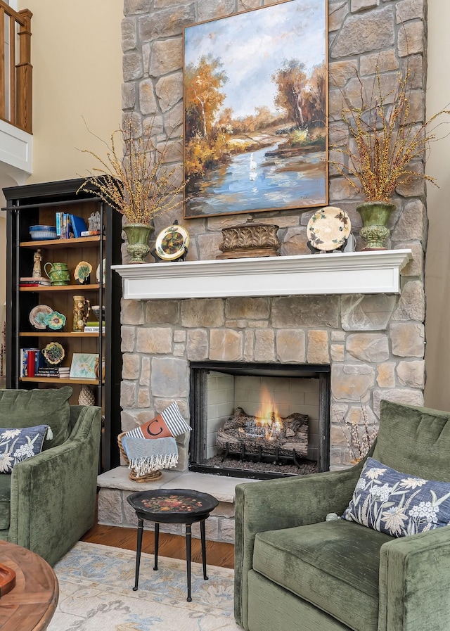 interior space featuring a stone fireplace and wood finished floors
