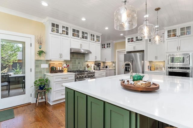 kitchen with premium appliances, white cabinetry, a sink, and light countertops
