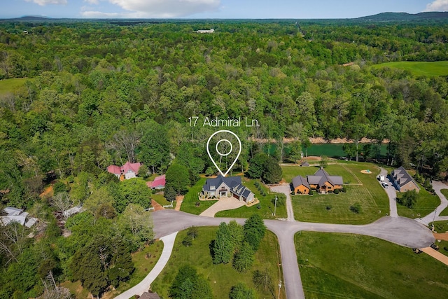 birds eye view of property with a wooded view