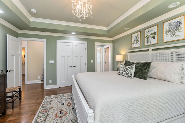 bedroom with ornamental molding, recessed lighting, dark wood-style flooring, a raised ceiling, and baseboards