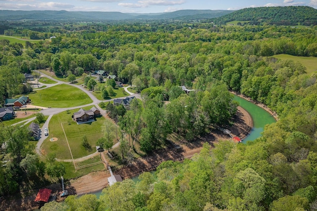 drone / aerial view featuring a wooded view