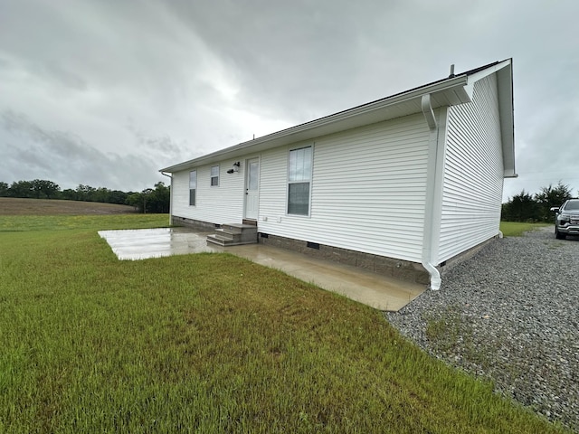 back of house featuring a patio area, crawl space, a lawn, and entry steps