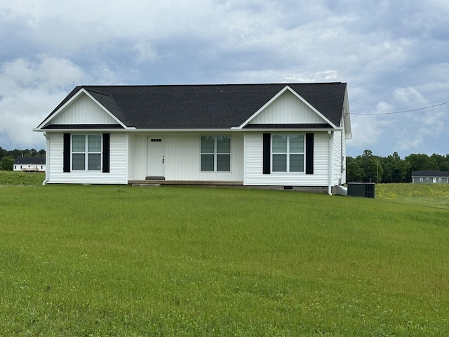 ranch-style house featuring a shingled roof, a front lawn, and cooling unit