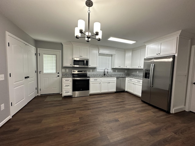 kitchen featuring a notable chandelier, a sink, dark wood-type flooring, white cabinets, and appliances with stainless steel finishes