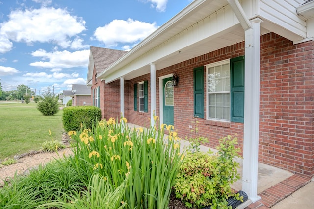 1876 Fall River Rd, Lawrenceburg, TN 38464 - view of home's exterior featuring brick siding, a porch, a lawn, and a shingled roof