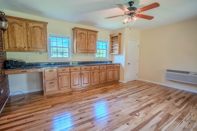 1876 Fall River Rd, Lawrenceburg, TN 38464 - kitchen featuring light wood-style flooring, a wall mounted AC, dark countertops, and open shelves